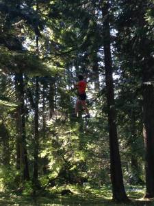 Yes that is actually me in a harness extremely high in the trees on a single wire. Not my favorite experience.